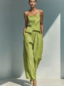 Fashionable two-piece set featuring diagonal button camisole and wide-leg pants in green