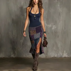 Close-up detail of bohemian style patchwork slit skirt with navy blue halter neck top