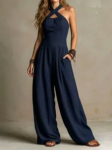Full view of navy blue ribbed knit halter-neck wide-leg jumpsuit with side pockets