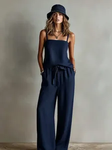 Stylish navy blue two-piece set featuring a spaghetti strap top and wide-leg trousers