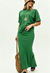 Full view of a model wearing a green casual two-piece set with loose top and long skirt.