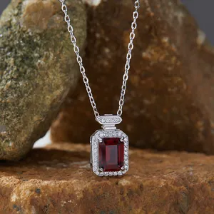 Detailed close-up of a rectangular red garnet pendant in a silver micro-pave setting.