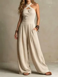 Detailed view of stylish criss-cross halter neck knit jumpsuit with wide-leg cut