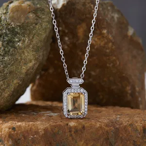 Detail view of emerald cut yellow topaz necklace on S925 silver with halo diamonds