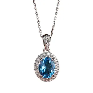 Elegante collar de plata S925 con colgante de topacio azul ovalado y borde de cristal