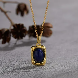 Close-up of vintage S925 silver necklace with oval lapis lazuli in textured gold frame