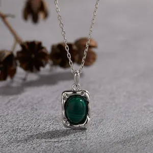 Close-up of a vintage S925 silver necklace featuring a natural oval malachite pendant