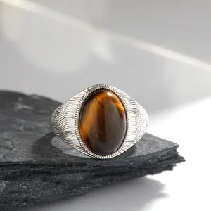 Primo piano di anello vintage in argento S925 con grande pietra ovale occhio di tigre