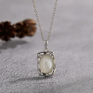 Close-up of S925 silver necklace featuring a vintage oval white mother-of-pearl pendant.
