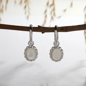 Detail of S925 sterling silver hoop earrings with elegant white mother-of-pearl oval inlays