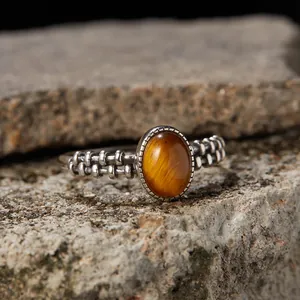 Close-up macro detail of natural tiger eye stone set in a retro Thai silver band ring