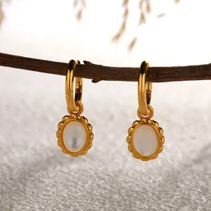 Close-up of S925 sterling silver gold-plated earrings with white mother-of-pearl charms