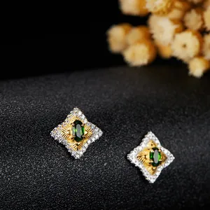 Dettaglio ravvicinato di eleganti orecchini a stella con diopside verde e diamanti scintillanti
