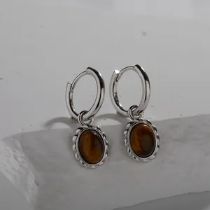 Detailed view of S925 sterling silver hoop earrings featuring natural oval tiger eye stones.