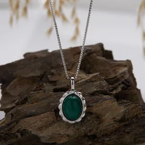 Detailed macro view of S925 sterling silver necklace with natural oval malachite pendant