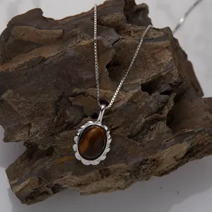 Close-up of S925 silver necklace featuring a natural oval tiger eye stone pendant