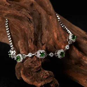 Vista detallada de pulsera de plata con gemas de diópsido verde y detalles halo