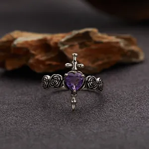 Close-up of vintage S925 sterling silver ring with amethyst heart and cross