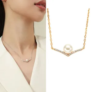 Close-up of elegant V-shape S925 silver necklace with freshwater pearl and crystal details.
