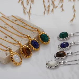 Detailed close-up showing oval malachite and lapis lazuli gemstone pendants in gold and silver