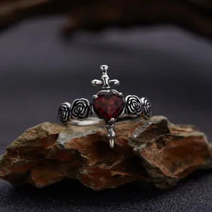 Close-up of S925 sterling silver ring featuring a red heart garnet and sword design