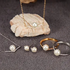 Elegant V-shaped jewelry set featuring natural freshwater pearls and crystal accents