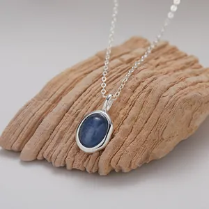 Detailansicht eines ovalen blauen Kyanit-Anhängers an einer S925 Sterlingsilberkette