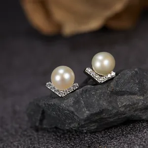 Detailed view of S925 sterling silver V-shaped stud earrings featuring elegant white pearls
