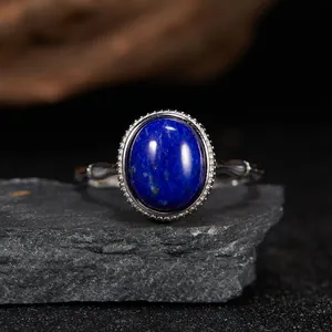 Close-up of an oval lapis lazuli gemstone inlaid in an S925 sterling silver ring.