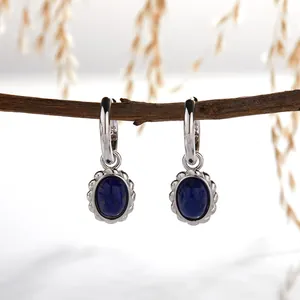 Macro view of vintage S925 sterling silver earrings with oval lapis lazuli stones