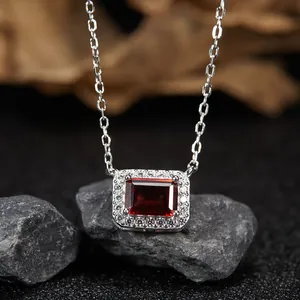 Close-up of elegant S925 sterling silver necklace with a rectangular red garnet pendant.