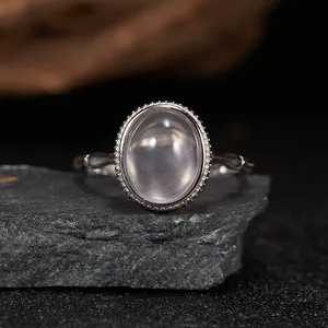 Detailed view of an oval semi-transparent gemstone ring in S925 silver on a stone