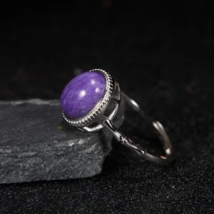 Close-up of S925 silver ring with oval natural purple charoite gemstone and bamboo band.