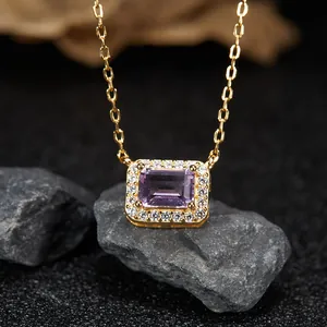 Close-up of elegant gold-plated silver necklace with rectangular purple amethyst pendant.