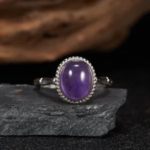 Detailed view of oval purple charoite gemstone set in vintage beaded silver ring