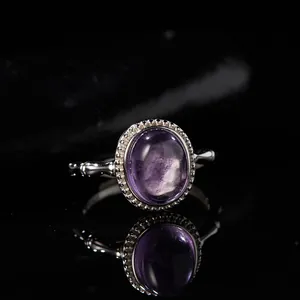 Macro view of an oval purple gemstone set in a textured S925 sterling silver ring