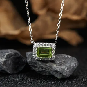 Close-up of S925 silver necklace with emerald-cut natural olivine pendant