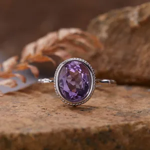Macro detail of oval-cut purple dragon crystal set in S925 sterling silver beaded ring