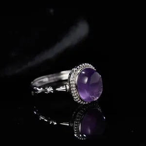 Macro view of an S925 sterling silver ring featuring a natural oval purple gemstone