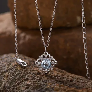 Nahaufnahme einer S925 Sterlingsilberkette mit einem hellblauen Natur-Topas-Anhänger