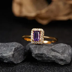 Close-up of elegant gold-plated sterling silver ring featuring a rectangular amethyst stone