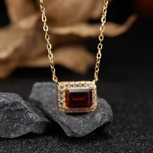 Close-up of elegant gold-plated sterling silver necklace with rectangular red garnet stone
