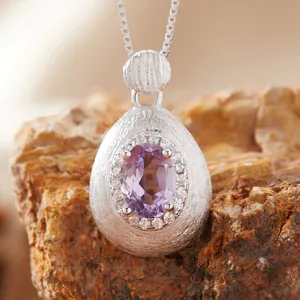 Detailed view of S925 silver pendant with amethyst gemstone and brushed finish texture.