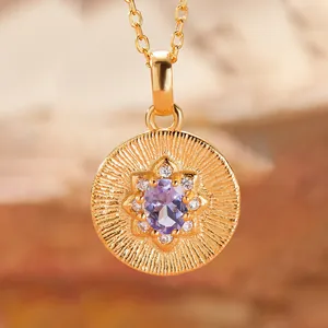 Detailed view of a gold tanzanite pendant featuring an intricate sunburst pattern.