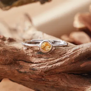 Macro detail of a natural round citrine set in an S925 silver adjustable ring band.