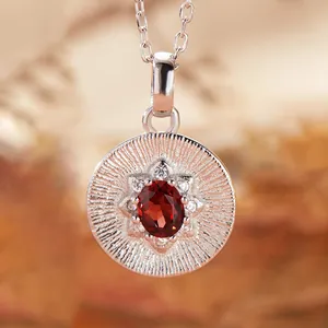 Macro view of S925 sterling silver necklace pendant with oval red garnet stone