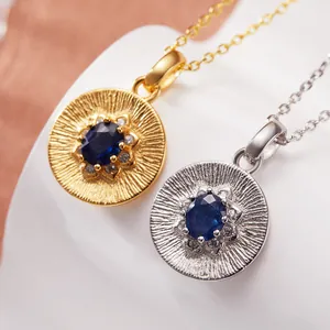 Macro detail of S925 sterling silver necklaces featuring round tanzanite gemstone pendants