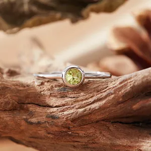 Detail view of a round yellow citrine gemstone set in a minimalist S925 silver ring