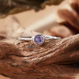 Macro view of a round purple amethyst gemstone set in a minimalist S925 silver ring.