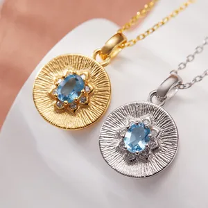 Macro view of S925 sterling silver necklaces with oval blue topaz gemstone pendants